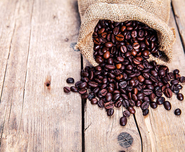 istock Coffee beans on the wooden background. Hot drinks. 598253736
