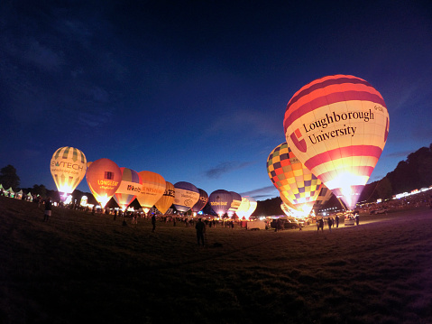 Bristol, UK: August 13, 2016: Night Glow at the Bristol International Balloon Fiesta. The annual event has become Europe’s largest hot air balloon festival. The Loughborough University balloon is to the fore of the image. 