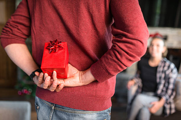 surprise for the girlfriend for christmas a surprise for the girlfriend for christmas hands behind back stock pictures, royalty-free photos & images