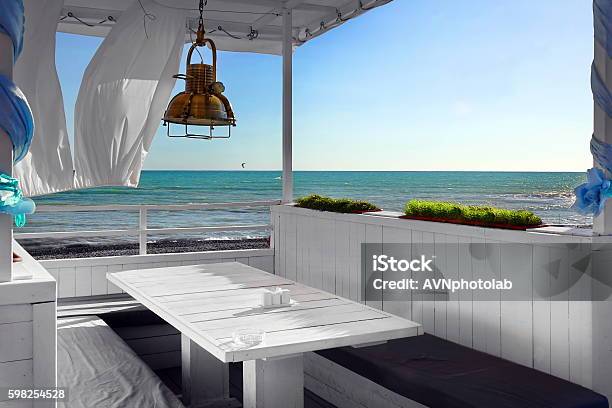 Seaview Restaurant Interior White Terrace With Wooden Furniture Stock Photo - Download Image Now