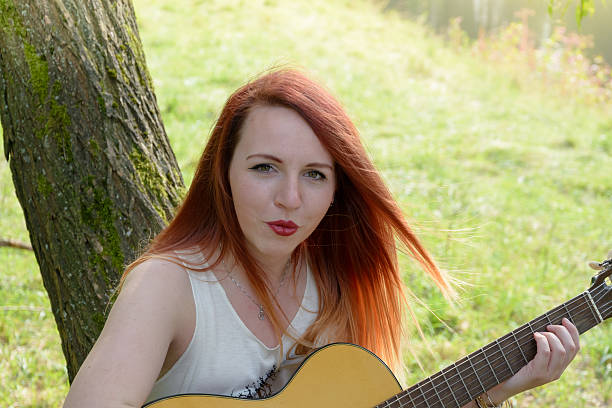 istock woman with guitar 598254908