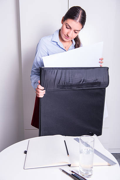 istock female engineer is taking drawings out of a big folder 598255270