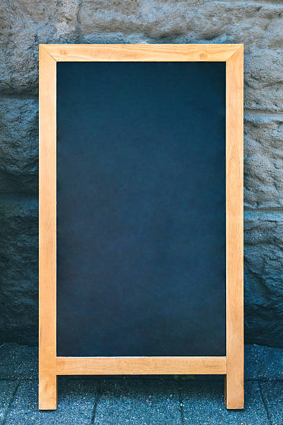 istock Vintage slate chalk board with wooden frame on stone background 598255682