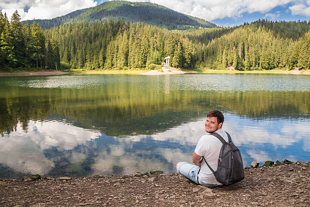 istock man at the lake beach 598255846