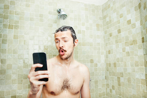 シャワーで自分撮りを取る男 - men naked shower bathroom ストックフォトと画像