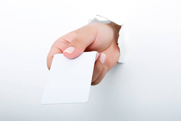 istock Female hand reaching through torn white paper sheet 598256720