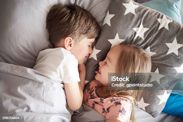 High Angle View On Sleeping Siblings Stock Photo - Download Image Now - Child, Bedtime, Pajamas