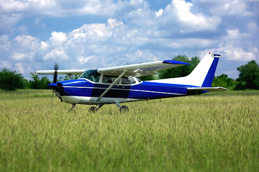 A small aircraft on a tarmac, surrounded by scenic mountain landscape, ready for a panoramic flight experience.