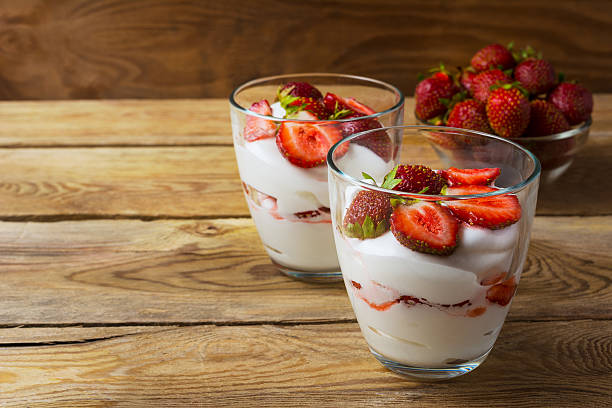 istock Layered strawberry dessert on wooden background 598258154