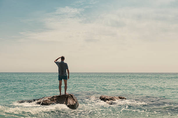 a young man is suffring from dipression and standing at sea cost
