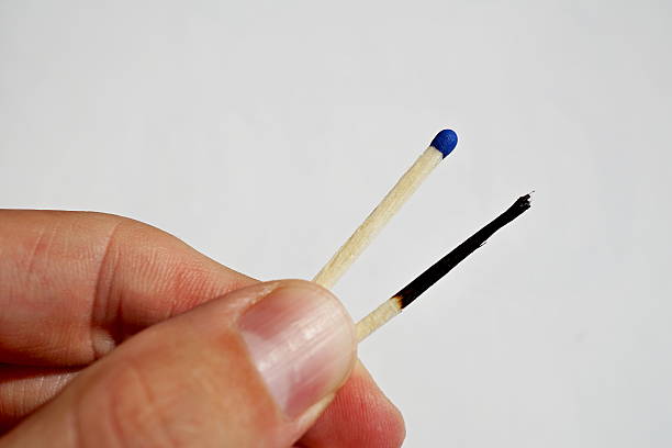istock Male hand holding burnt and unlit safety matches 598259854