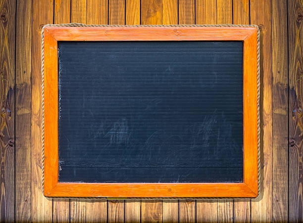 istock Front view of a blank blackboard over wooden surface 598260440