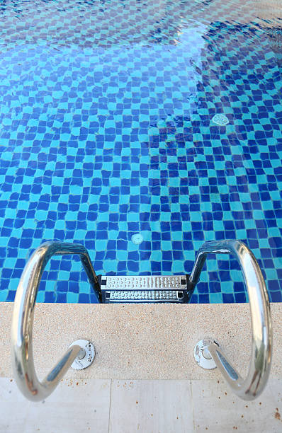 istock swimming pool with steel stair 598261286