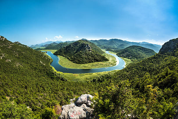Famous Rijeka Crnojevica in Montenegro with surrounding area on a clear sunny day.