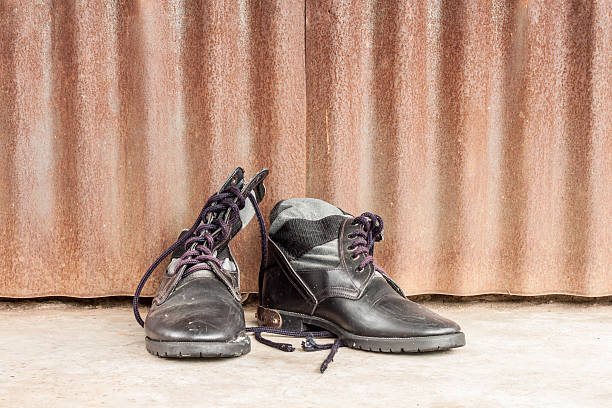 istock combat boots on cement floor, zinc wall 598522604
