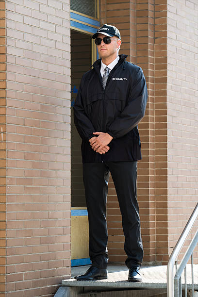 istock Male Security Guard Standing At The Entrance 598522742