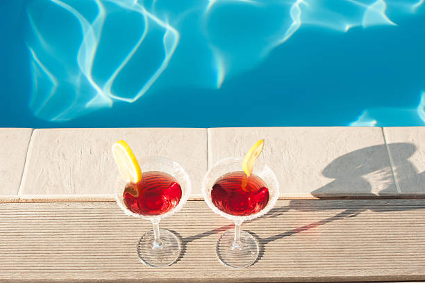 istock Two cocktails beside a swimming pool 598523776