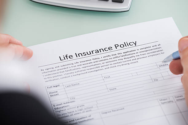 istock Person Filling Life Insurance Policy Form 598524772