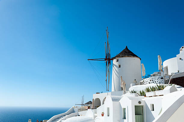 istock Windmill in Oia with blue sky and sea in Santorini 598524876