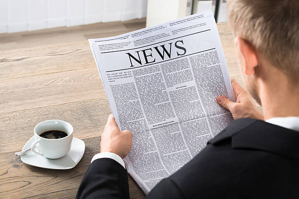 istock Businessman Reading Newspaper In Office 598525282