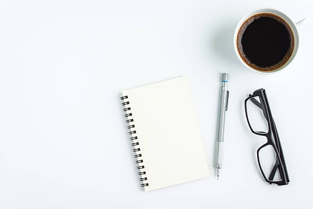 istock cop of coffee with notebook on white background 598525342