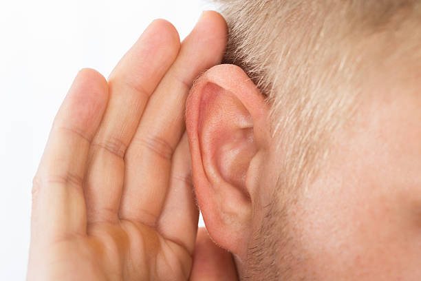 istock Person Trying To Hear With Hand Over Ear 598526428