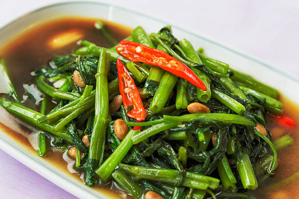 Stir-fried morning glory - Thai food A hot and spicy stir-fried morning glory is a Thai's favorite dish and very easy to make.  morning glory photos stock pictures, royalty-free photos & images