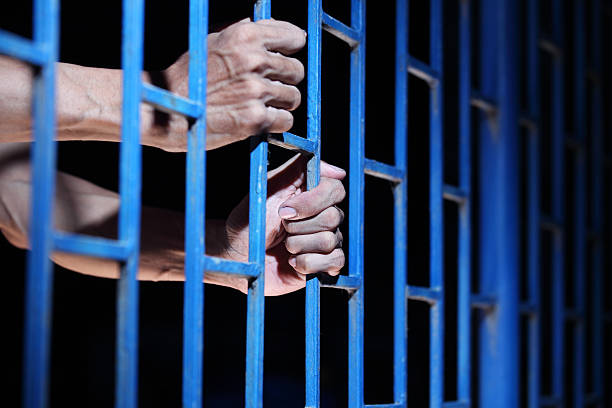 istock hand of prisoner in jail 598528898