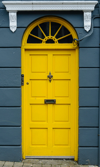 Door of a residential building in Dublin, Ireland, coloured in yellow