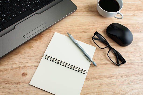 istock office table with glasses,  pencil and note book, business conce 598529770