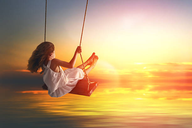 istock child girl on swing 598530178