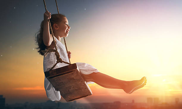 istock child girl on swing 598530240
