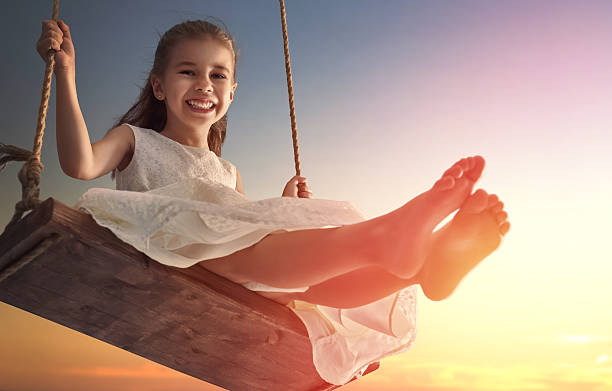 istock child girl on swing 598530304