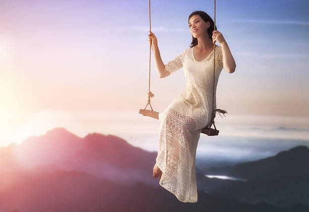 istock young woman on a swing 598530654