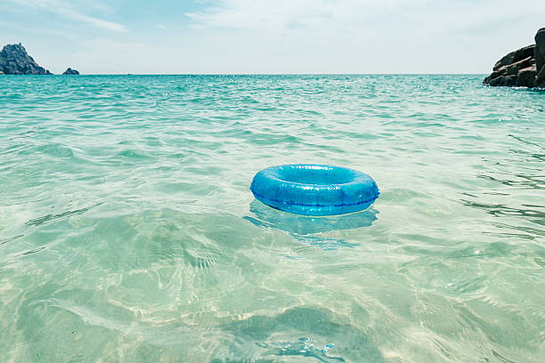 Rubber ring floating in the clear blue sea Pedn Vounder  Beach, Cornwall,  June morning.