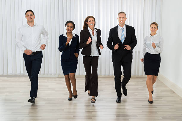 istock Businesspeople Together Running In Office 598531814