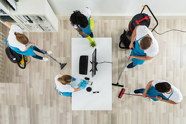 istock Janitors Cleaning The Office With Cleaning Equipments 598532012