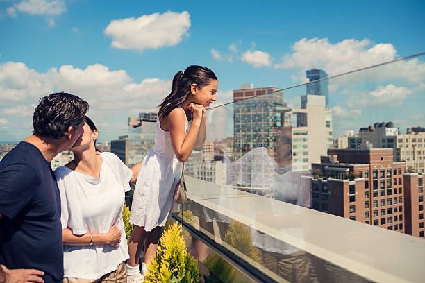 istock Daughter looking at New-York skyline while parents are kissing. 598533270