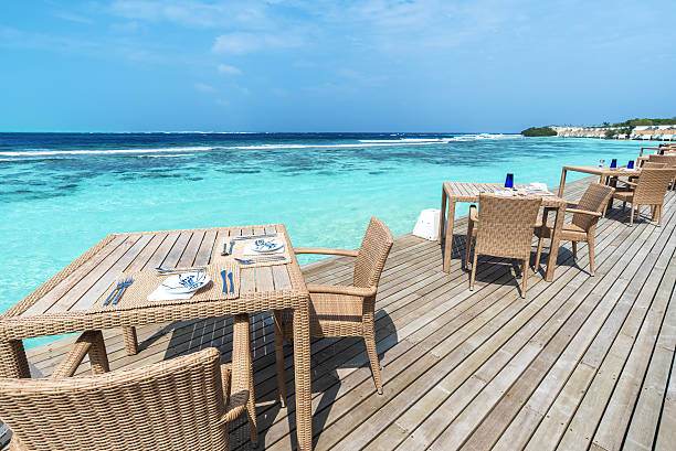 istock Restaurant tables and chairs on the sea view terrace 598534310