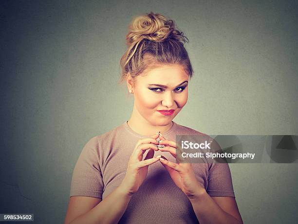 Sneaky Sly Scheming Woman Plotting Something Stock Photo - Download Image Now - Conspiracy, Human Face, Mischief