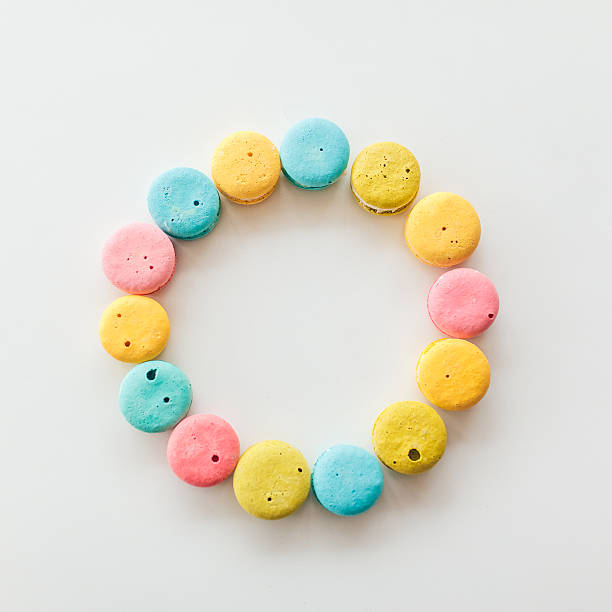 French macaroons laid out in a circle shape on white