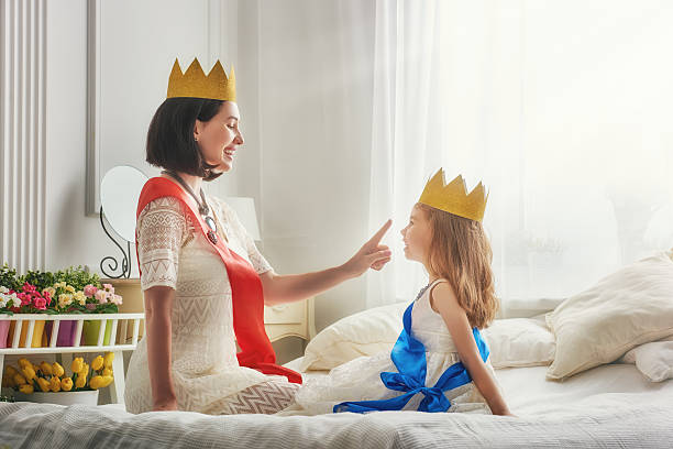 istock queen and princess in gold crowns 598535596