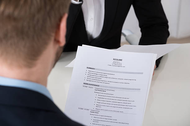 istock Businessman Analyzing Resume At Desk 598537210