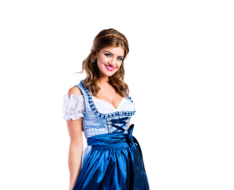 Beautiful young woman in traditional bavarian dress standing, Beer Fest. Studio shot on white background, isolated.