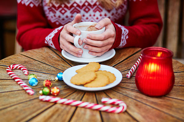 istock woman drinking hot chocolate in cafe decorated for Christmas 598537748