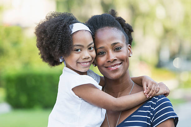 istock Mother with beautiful mixed race young daughter 598537788