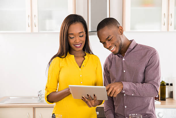 istock Happy Young Couple Standing In Kitchen 598539602