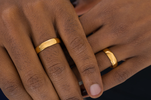 Close-up Of African Hands Wearing Golden Rings