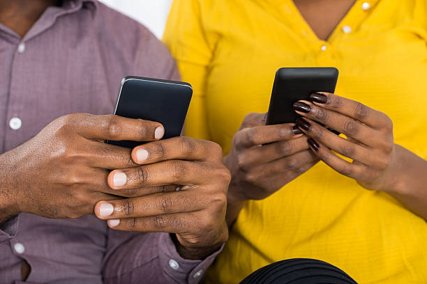 istock Couple Holding Mobile Phones In Hand 598540014