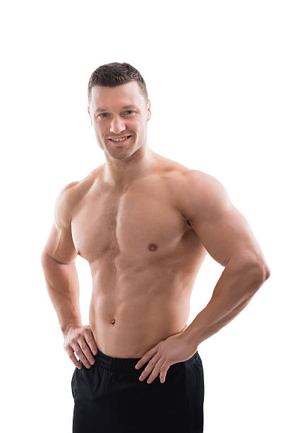 istock Happy Muscular Man Standing With Hands On Hip 598541656